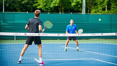 Padel players in action on the court.